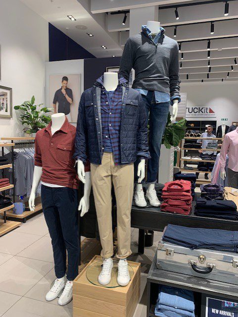 Menswear mannequins styled with coordinated looks for UNTUCKit Westfield London visual merchandising update.