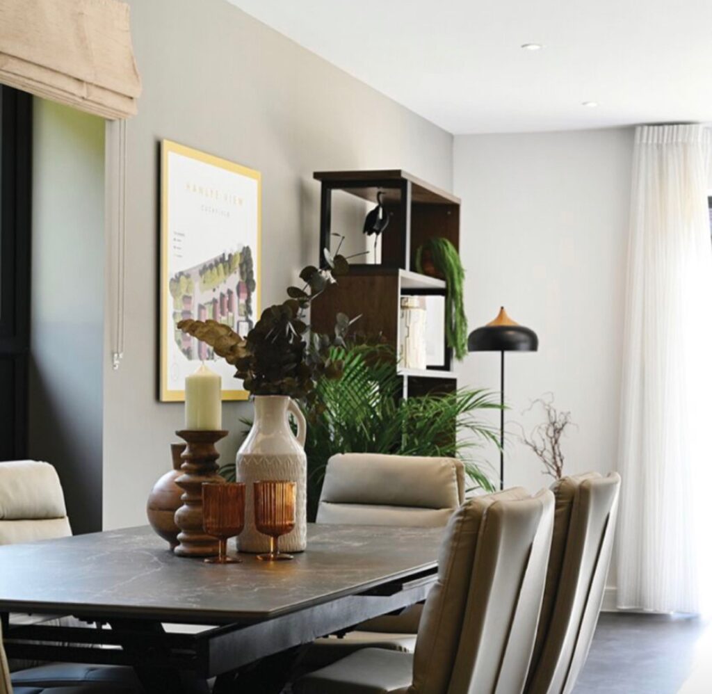 Dining room and open‑plan living area styled with layered textures and coordinated décor for DFAO showhome project in Brighton.